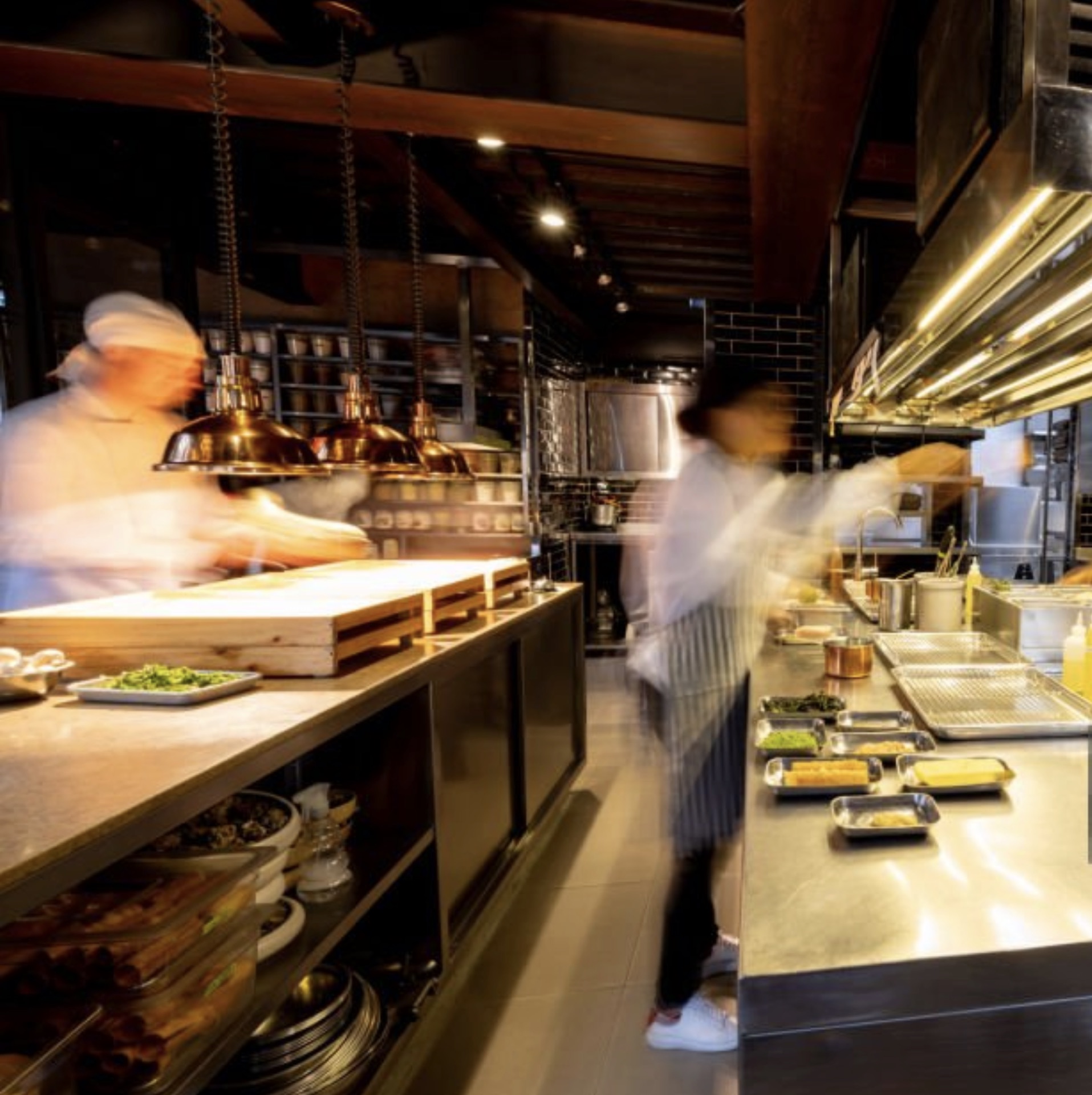 Cooks working a busy kitchen pass